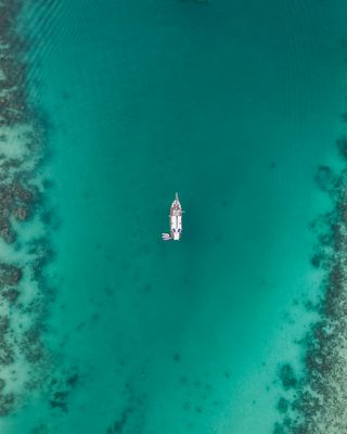 A boat on a river, taken from the sky